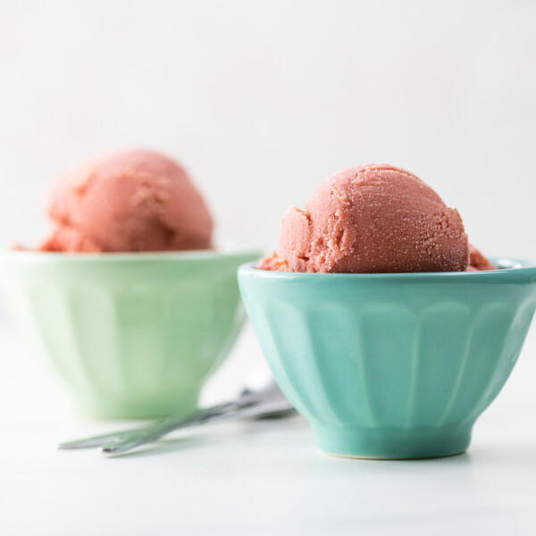 sour cherry frozen yogurt scooped into small bowls with spoons