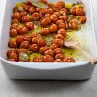 tomato confit in a white roasting pan
