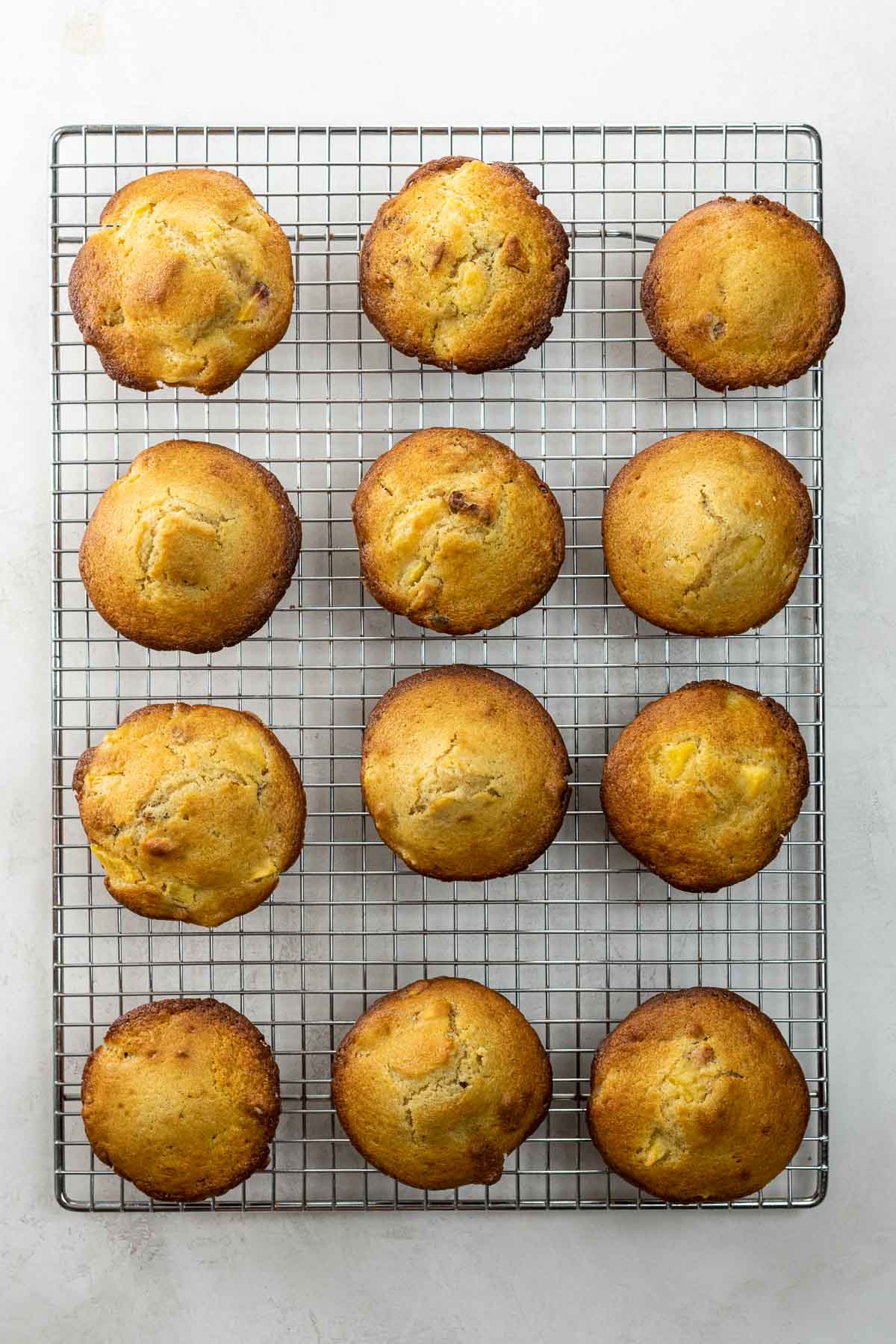 a dozen muffins on a cooling rack