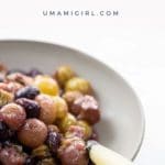 roasted grapes in a bowl with a spoon