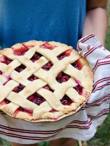 holding a sour cherry pie