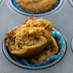 an open banana sweet potato muffin in a muffin tin