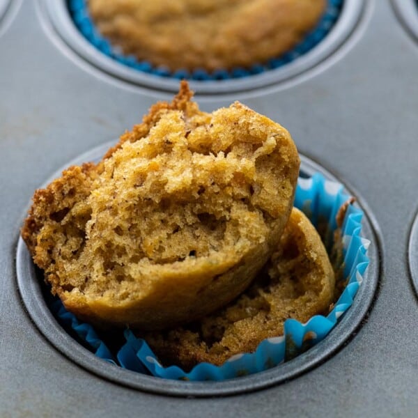 an open banana sweet potato muffin in a muffin tin