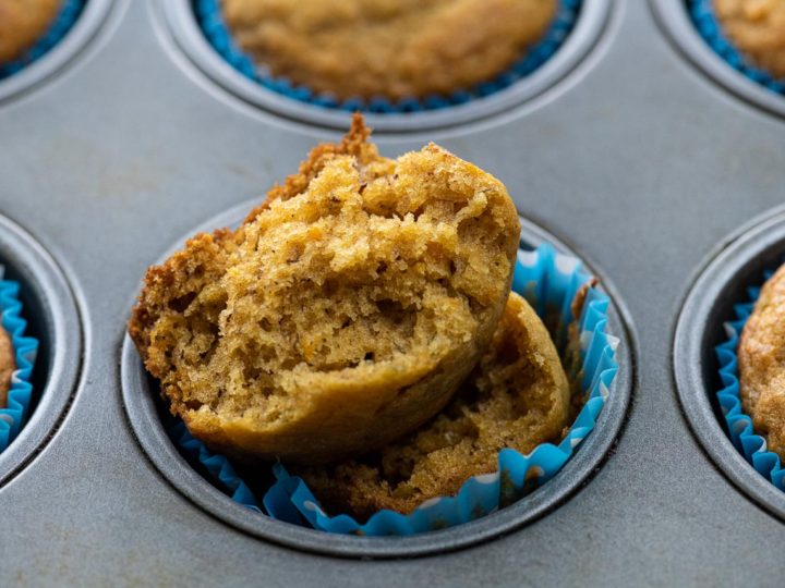 an open banana sweet potato muffin in a muffin tin