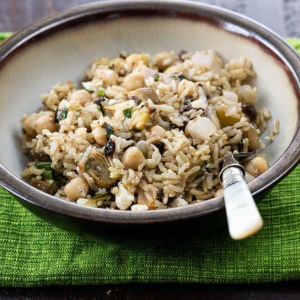 brown rice salad in a bowl with a fork