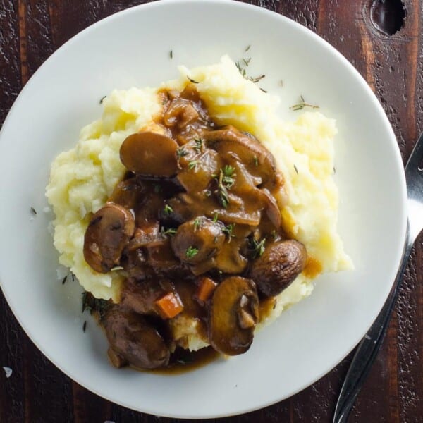 mushroom bourguignon (vegan option) on a plate with mashed potatoes