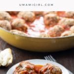 traditional Italian meatballs in tomato sauce on a plate with a fork and crusty bread