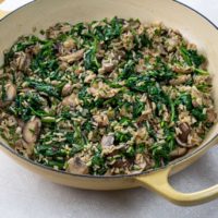 mushroom spinach rice in a pan