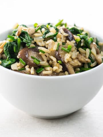 spinach mushroom rice in a white bowl