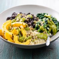 a quinoa power bowl with winter squash, spinach, and black beans