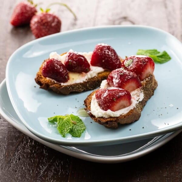 strawberry goat cheese bruschetta on a blue plate