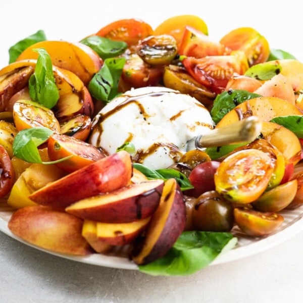 burrata caprese salad with nectarines on a serving plate