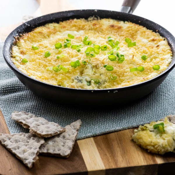 popper dip (jalapeno dip with cream cheese and panko) in a skillet with crackers