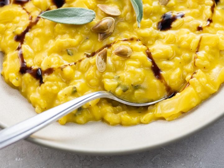 creamy roast pumpkin risotto with sage in a wide, shallow bowl