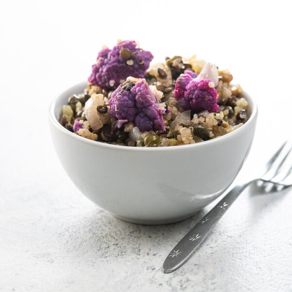 warm quinoa salad with lentils and cauliflower in a white bowl