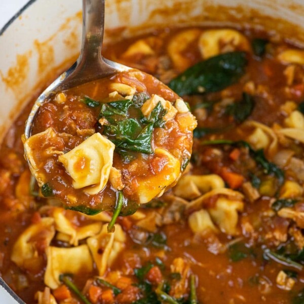 creamy chicken tortellini soup in a pot and a ladle
