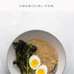 savory steel cut oats with a seven minute egg and crispy broccolini in a bowl with a spoon