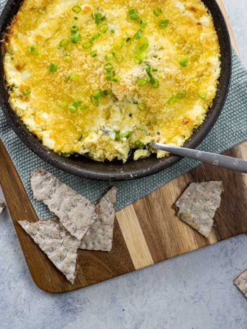 popper dip (jalapeno dip with cream cheese and panko) in a skillet with crackers