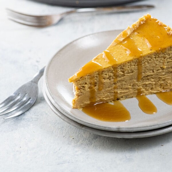 a slice of spiced pumpkin cheesecake on a plate