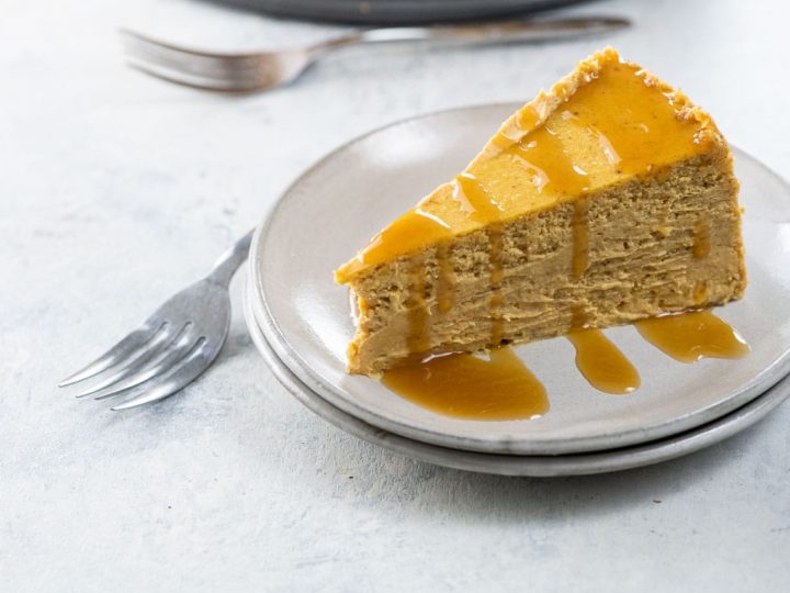 a slice of spiced pumpkin cheesecake on a plate