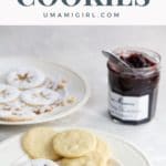 shortbread linzer cookies on plates with a jar of jam