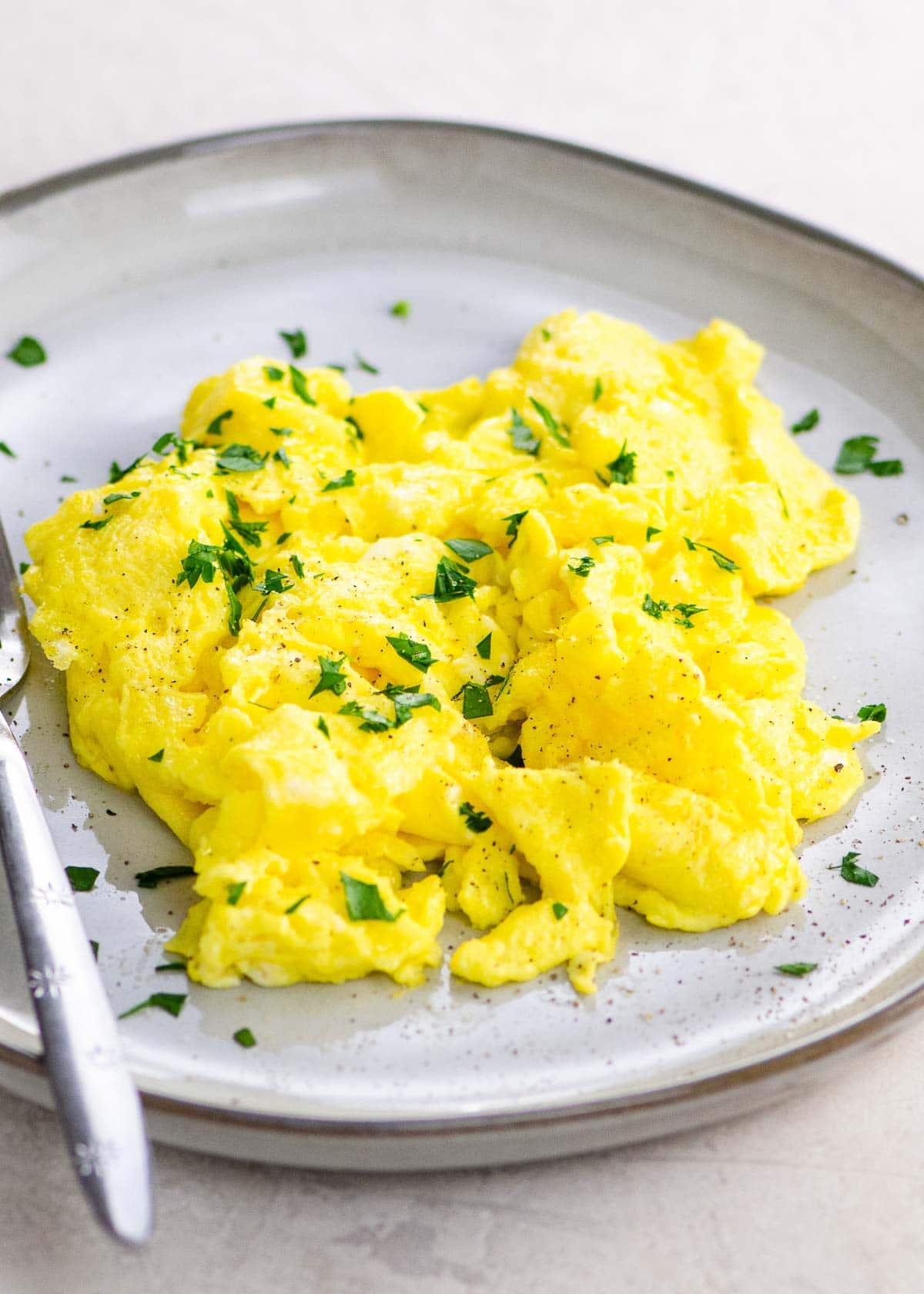 American scrambled eggs on a plate with a fork