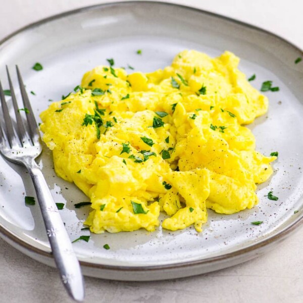American scrambled eggs on a plate with a fork