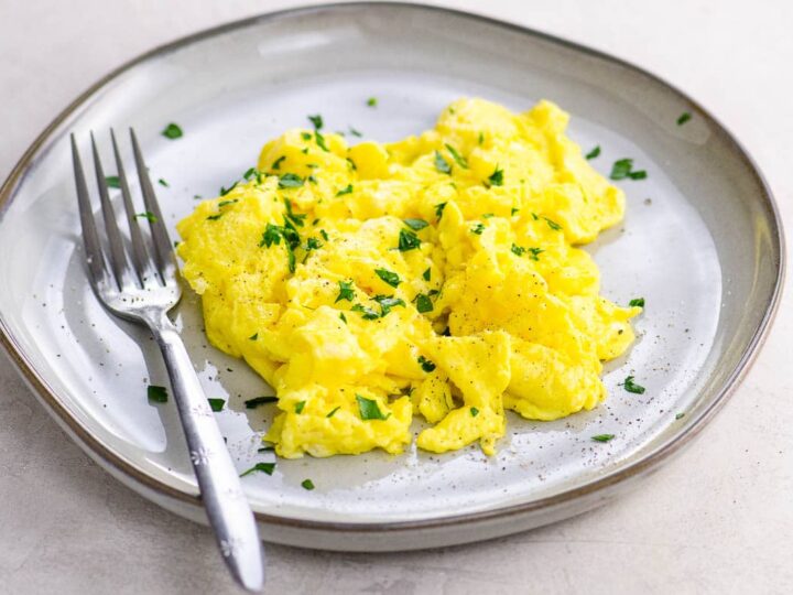 American scrambled eggs on a plate with a fork