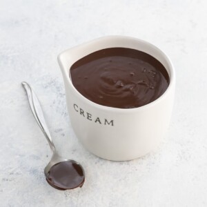 chocolate ganache ratio 1 to 1 in a small pitcher and on a spoon