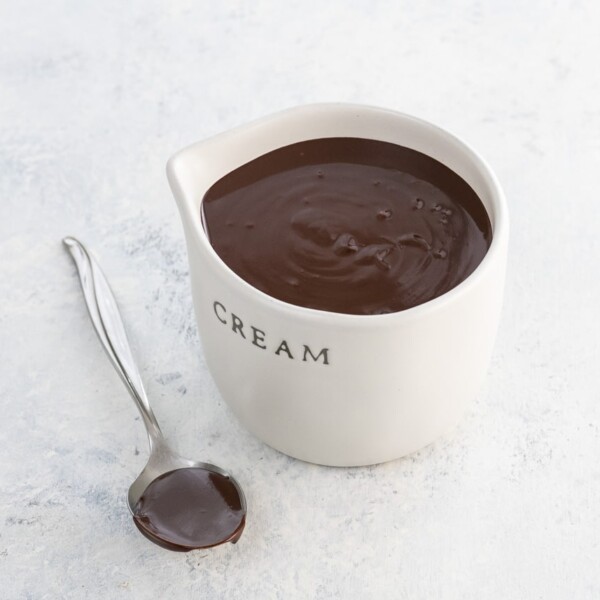 chocolate ganache ratio 1 to 1 in a small pitcher and on a spoon