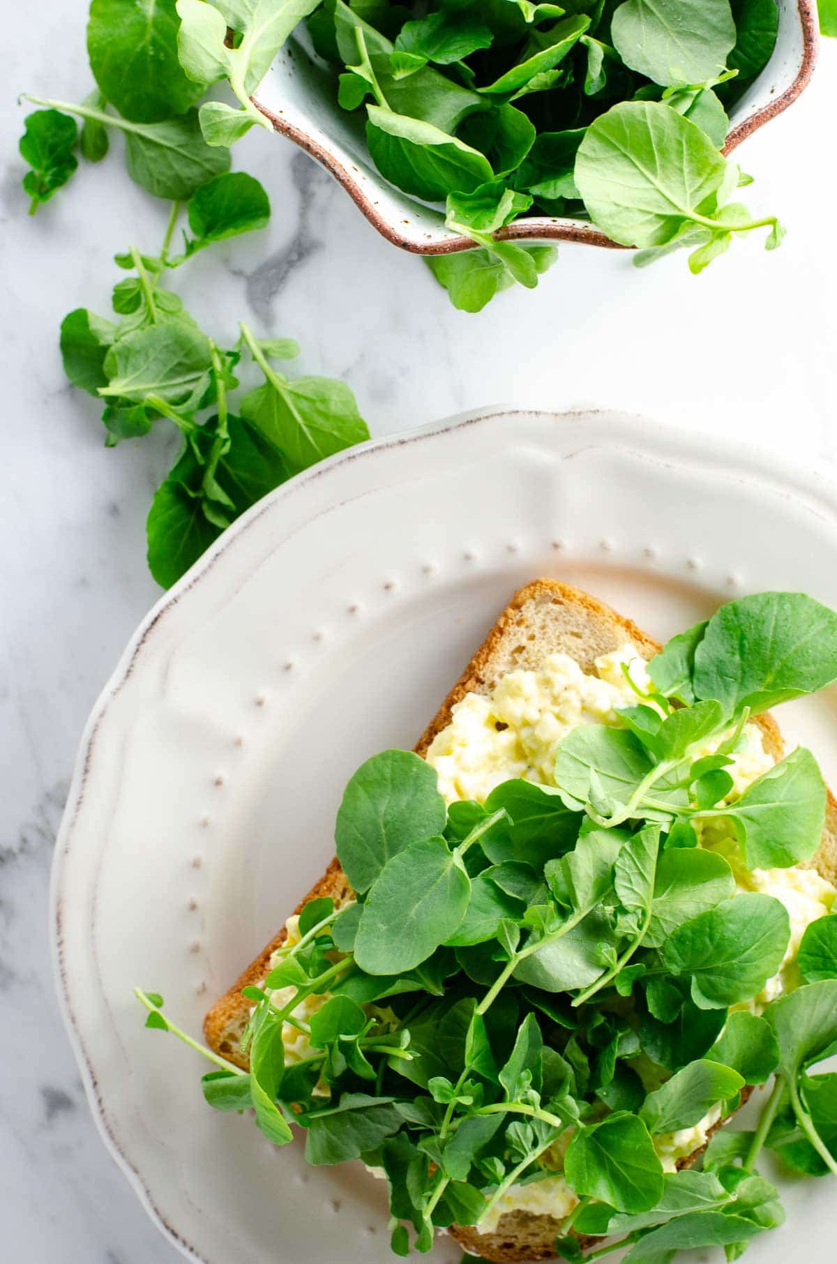 An egg and cress sandwich on a plate