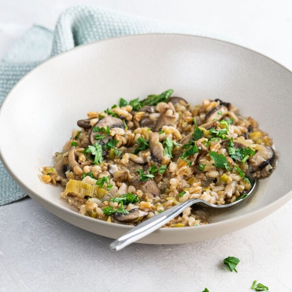 mushroom farrotto in a bowl with a spoon