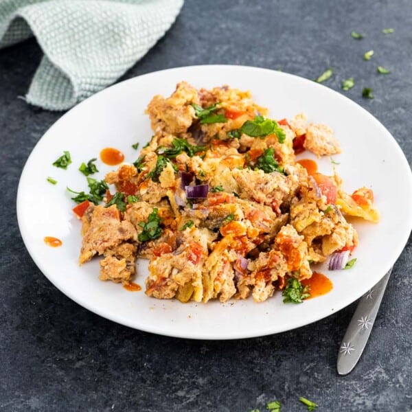 migas breakfast on a plate with a fork and napkin