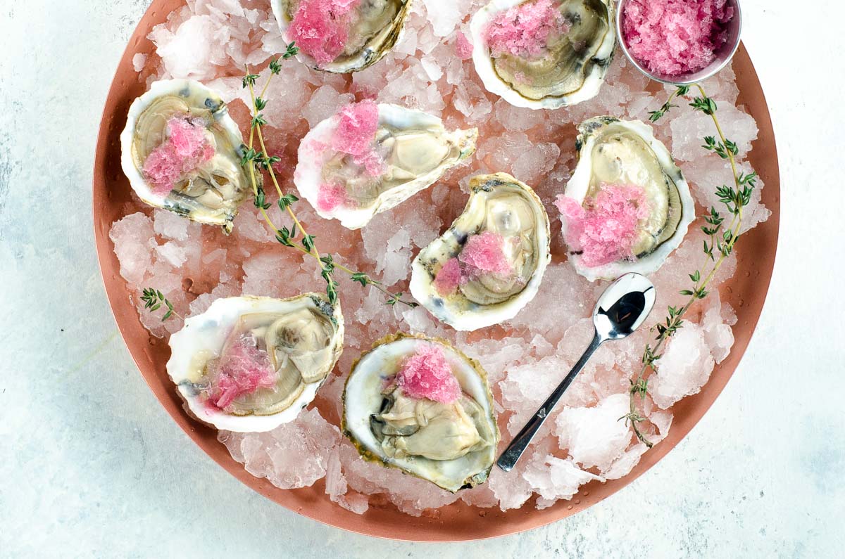 oysters on the half shell with mignonette granita on a platter over crushed ice