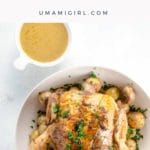 Roast chicken and potatoes in a serving bowl with gravy