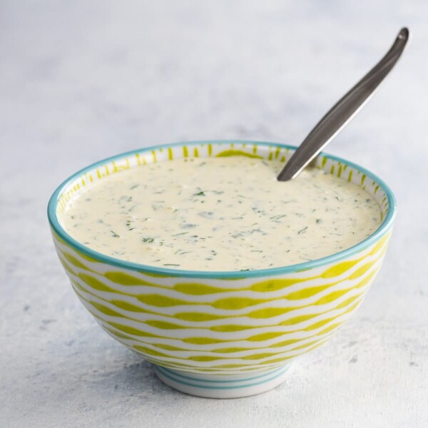 cilantro mayo in a bowl with a spoon