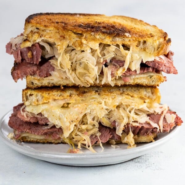 corned beef on rye (Reuben sandwich) cut in half on a white plate