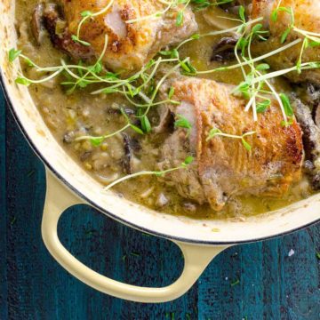 chicken thighs with leeks, mushrooms and white wine in a dutch oven