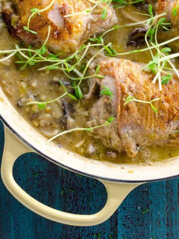 chicken thighs with leeks, mushrooms and white wine in a dutch oven