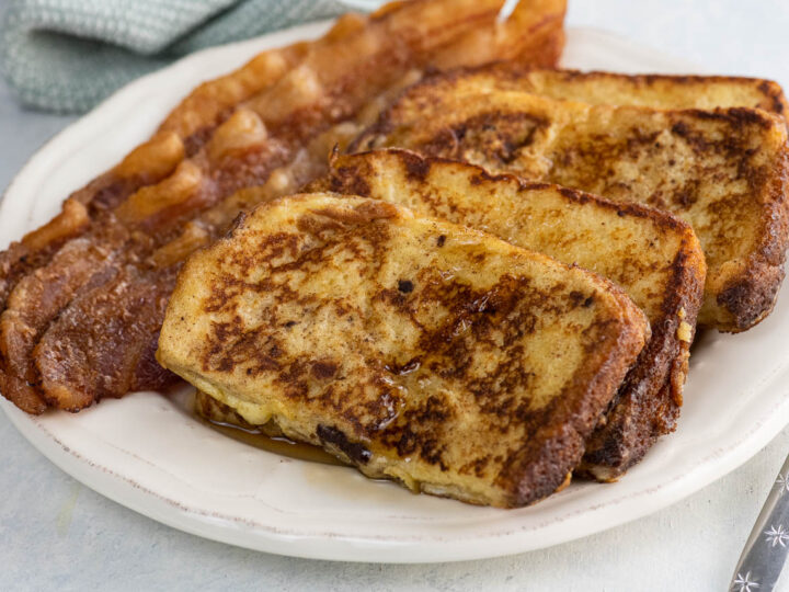 everyday french toast and bacon on a plate with a fork and napkin