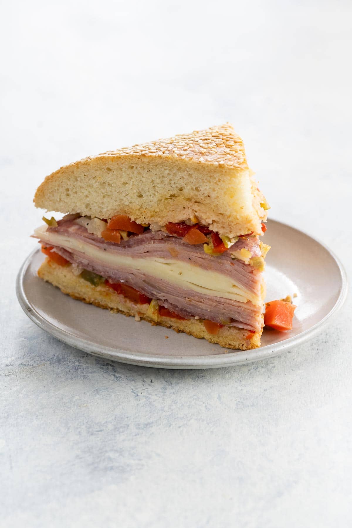 a classic muffaletta sandwich on homemade muffaletta bread