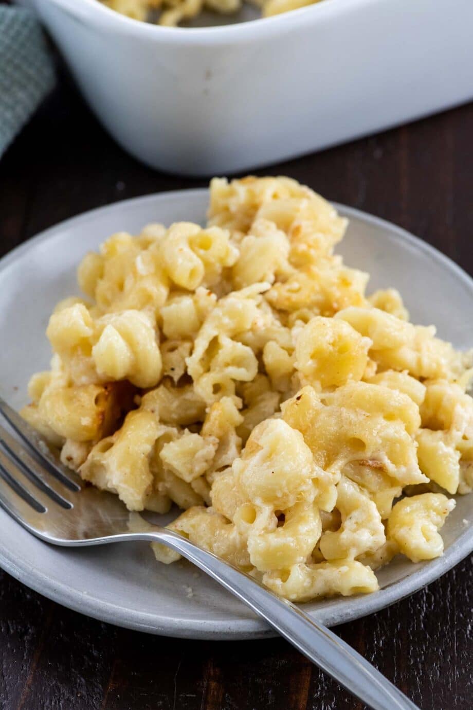 old fashioned baked macaroni and cheese on a plate with a fork and napkin