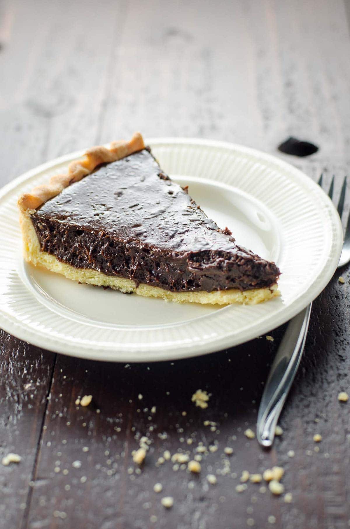 a slice of chocolate tart with shortbread crust
