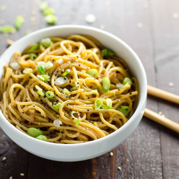 spicy sesame garlic noodles in a bowl with chopsticks