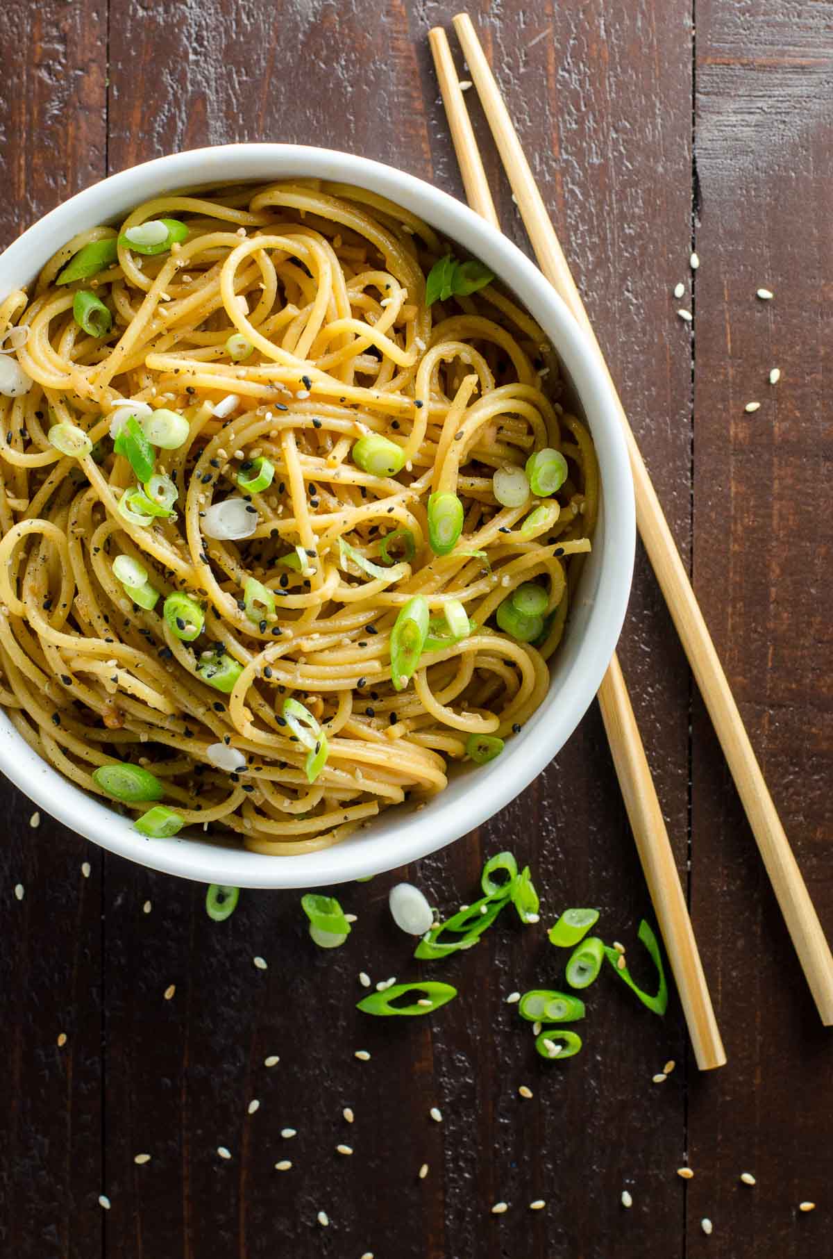 spicy sesame garlic noodles in a bowl with chopsticks