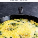 a spinach cheddar corn frittata in a cast iron pan
