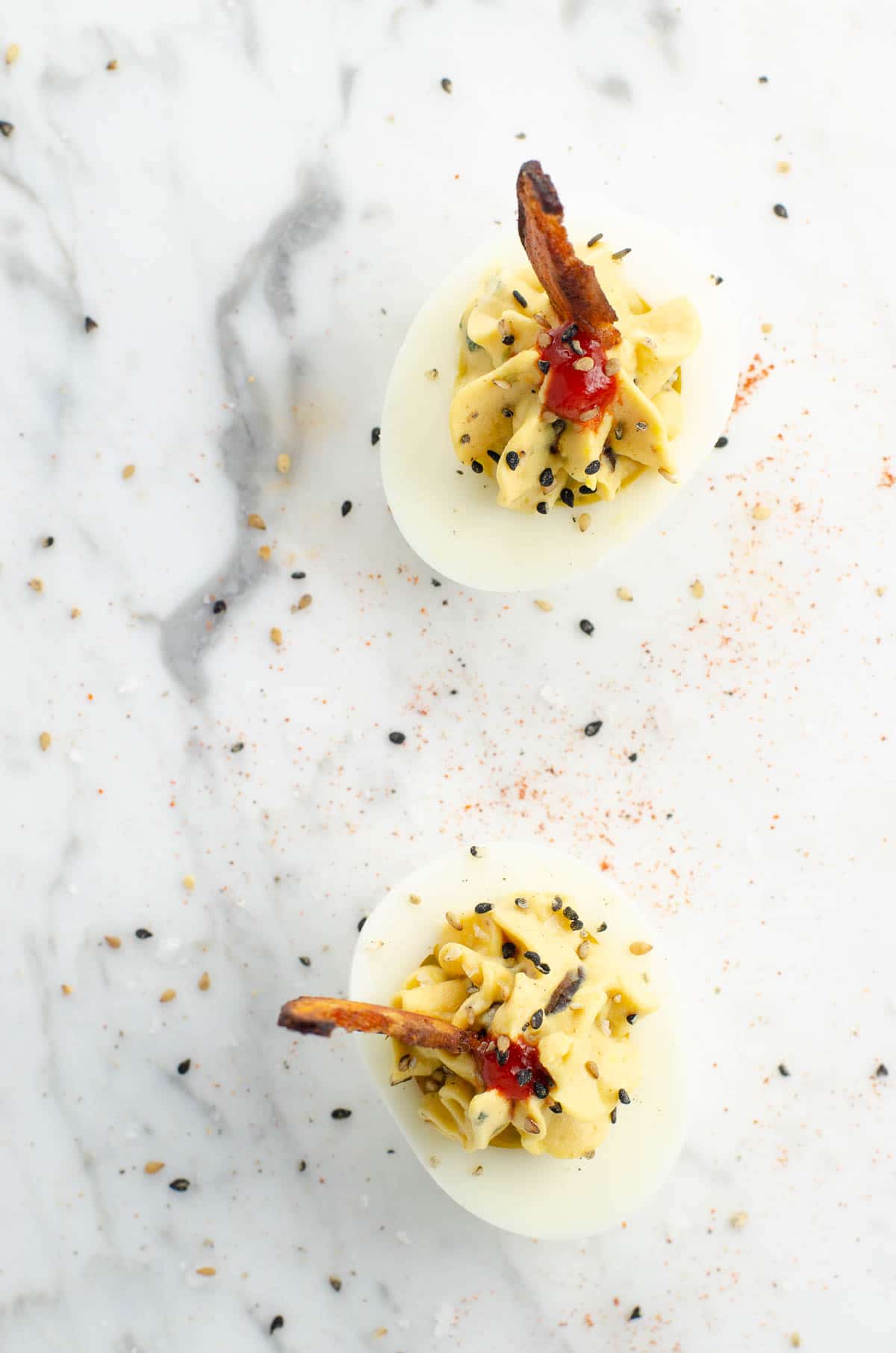 an ultimate miso deviled egg on a marble background