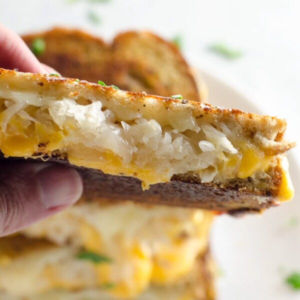 sauerkraut grilled cheese with dijon in a hand
