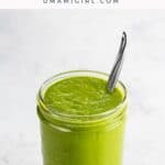 green enchilada sauce in a jar with a spoon