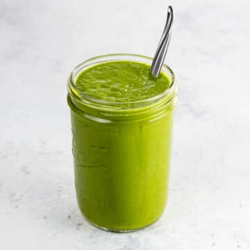 green enchilada sauce in a jar with a spoon